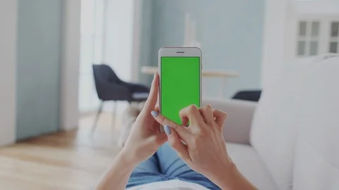 Green Screen or Mock-up Tracking. Girl Using Smartphone at Cozy Home. Tapping Stock Footage 122415368