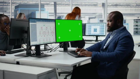 Green screen PC, analyzing PCB architecture and man in semiconductors factory Stock Footage 335880489