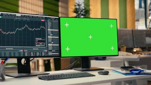 Green screen PC displaying stock market graphs in proprietary firm office Stock Photos