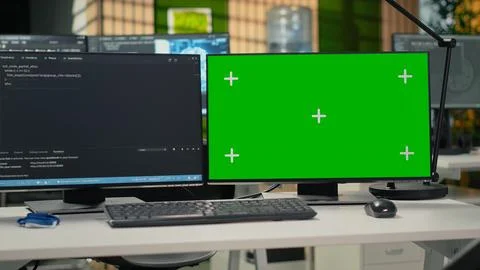 Green screen PC in empty startup office with programming language script Stock-Fotos