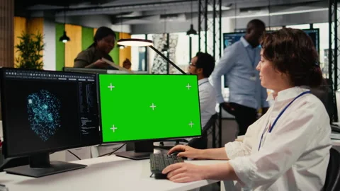 Green screen PC used by developer in office, using AI specialized hardware Video stock 323030282
