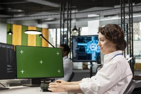 Green screen PC used by programmer in office automating repetitive tasks with AI Foto stock