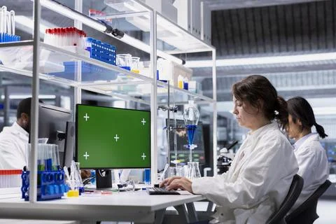 Green screen PC used by scientist in laboratory to process DNA patient data 写真素材