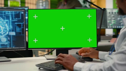 Green screen PC used by technician in startup office working with AI Stock Footage 322697918