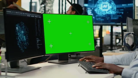Green screen PC used by technician in office using AI to optimize systems Stock Footage 323143437