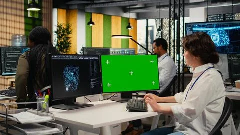 Green screen PC used by technician in office using AI to optimize systems Foto stock