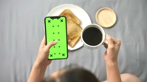 Green screen phone and human hand, woman has a green screen smart phone in cafe Stock-Footage 336585726