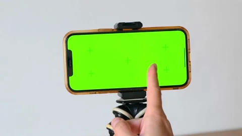 Green screen phone. Close-up of finger swiping smartphone screen with motion Video stock 226732289