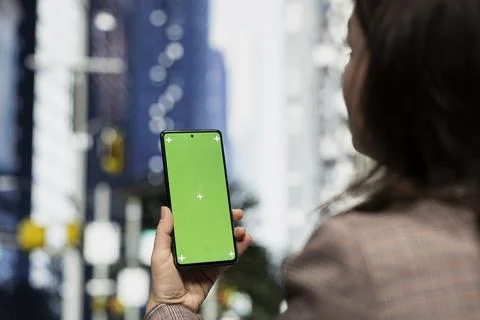 Green screen phone map application used by woman Stock Photos