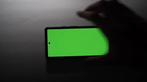 Green screen on phone in moody light atmosphere Stock Footage 256956463