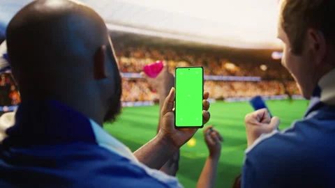 Green screen phone used by man celebrating winning football match bet Video stock 337555996