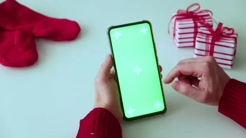 Green screen pnone in hands. Christmas time Stock Footage 164833697