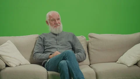Green Screen. Relaxed Old Man with a Gray Beard Resting Sitting on Sofa. Video stock 263397019