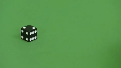 Green screen shot of a black dice rolling 2 Stock Footage 117989355