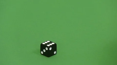 Green screen shot of a black dice rolling 6 Stock Footage 117989741