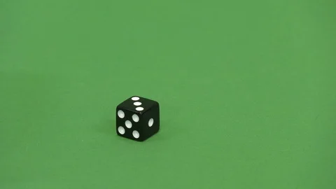 Green screen shot of a black dice rolling 3 Stock Footage 117989771