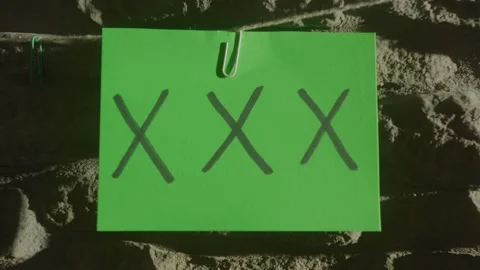 A green screen shot with a card hung on a wall, perfect for motion tracking. Stock Footage 305144549