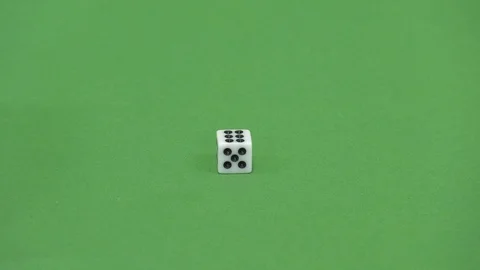 Green screen shot of a white dice rolling a 6 Stock Footage 118134129