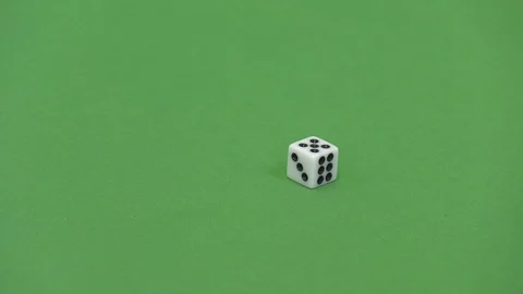 Green screen shot of a white dice rolling a 6 Stockbeeldmateriaal 118134158
