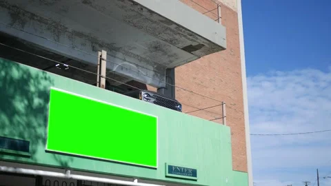 A green screen sign over a generic parking garage shot on tripod for corner  Stock Footage 287395258