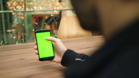 Green screen smartphone browsing in the mall with lights in background Stock Footage 84313257