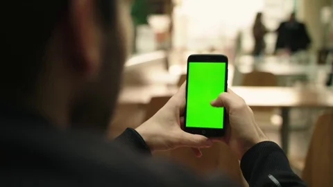 Green screen smartphone in a mall cafeteria scrolling Stock Footage 84688907