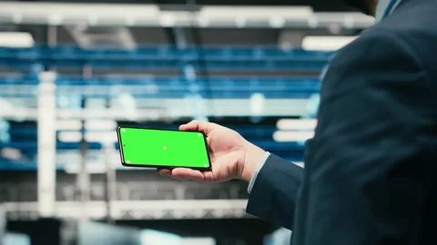 Green screen smartphone, managing wireframe mesh gear and admin in data center Stock Footage 329591679