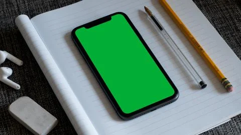 A Green Screen Smartphone on Notebook Stock Photos
