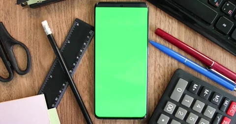 Green screen smartphone on the office table top view Stock Footage 134075287