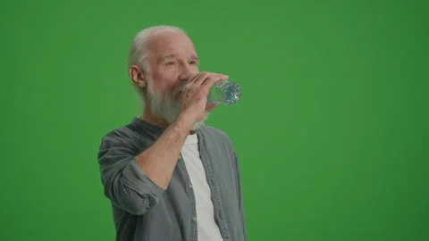 Green Screen. A Smiling Old Man Drinks Water From a Bottle. Video stock 262224534