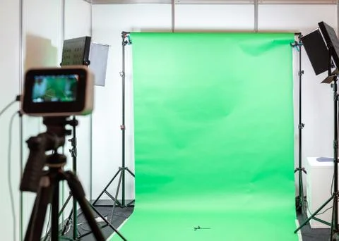 Green screen studio background. Filming or photography studio set with lights Stock Photos