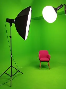 A green screen studio with complete lighting equipment. With a red chair. Stock Photos