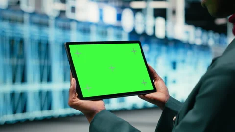 Green screen tablet in data center and augmented reality used by developer Stock Footage 329531466