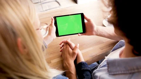 Green screen on tablet device, Young couple watching together - Mock up Stock Footage 89828406