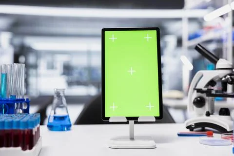 Green screen tablet in empty lab with software used to analyze genetic markers Stock Photos