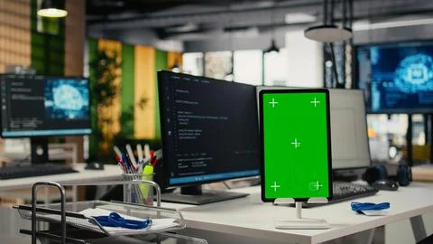 Green screen tablet in empty startup office with neural network program running 库存照片