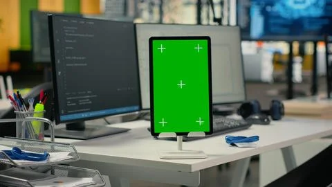 Green screen tablet in empty startup office with neural network program running 库存照片