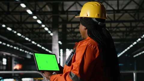 Green screen on tablet held by black woman in industrial engineering plant Stock Footage 330087989