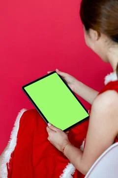 Green Screen Tablet Mockup Image Featuring an Asian Woman With Christmas At.. Stock Photos