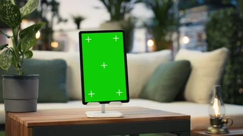Green screen tablet on rooftop table with leafy plants, close up Stock Footage 345166149