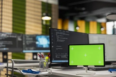Green screen tablet running advanced AI algorithms in empty startup office Foto stock