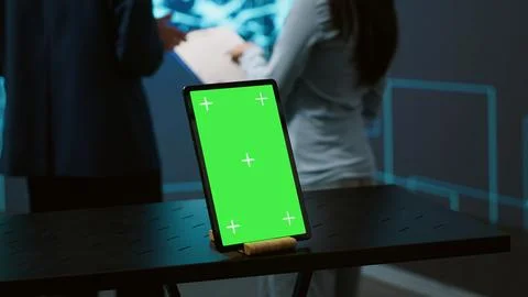 Green screen tablet used by computer scientists in AI startup Stock Photos