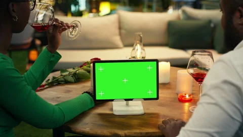 Green screen tablet used by couple during candlelit rooftop date Stock Footage 347083095