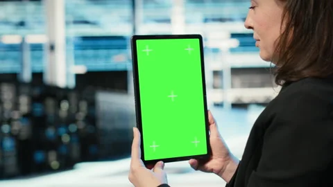 Green screen tablet used by data center admin to optimize server load balancing Stock Footage 329326898