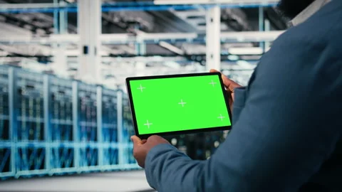 Green screen tablet used by data center worker to manage cloud computing Stock Footage 330206132