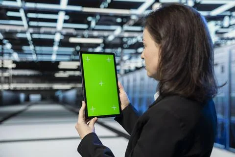 Green screen tablet used by data center admin to do checkup Stock Photos