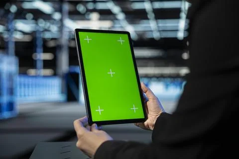Green screen tablet used by data center admin to troubleshoot infrastructure Stock Photos