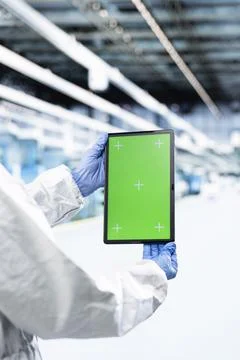 Green screen tablet used by hardware designer working in CPU parts factory Stock Photos