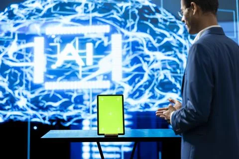 Green screen tablet used by tech startup computer scientist projecting AI Stock Photos