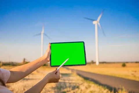 Green screen tablet on the windmills background. Chroma key. windmills green Stock Photos